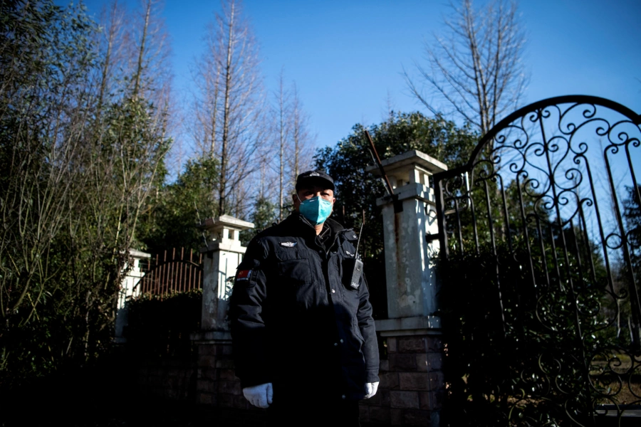 A guard stands at the gate of the Shanghai Public Health Clinical Center in China, February 17, 2020.